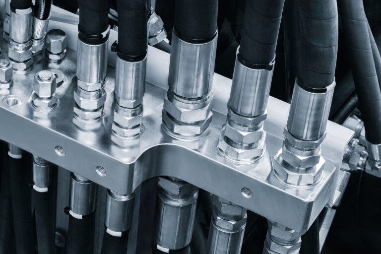 Close-up of hydraulic hoses and fittings for construction equipment service
